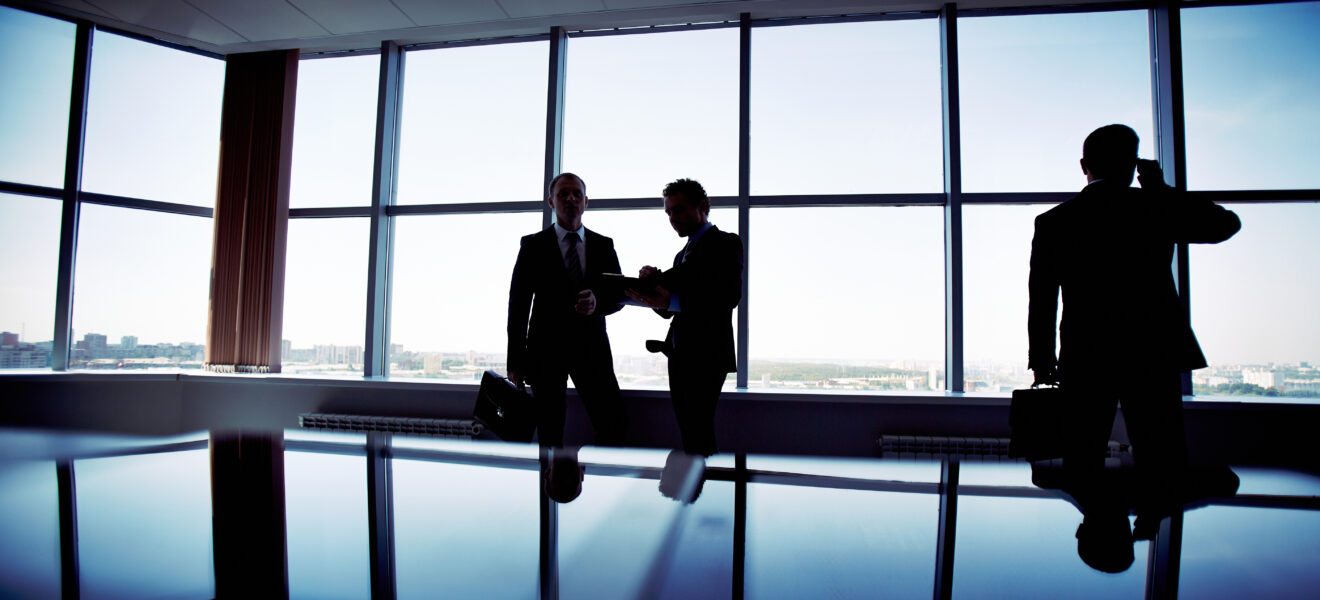 silhouettes employees working together scaled